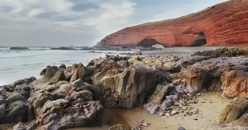 egzira Beach natural rock arch at low tide Morocco