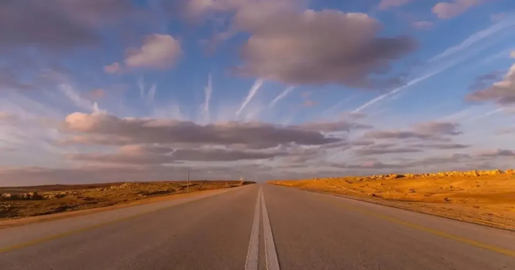 Comparison between regular sedan and 4x4 vehicle on paved road to Merzouga